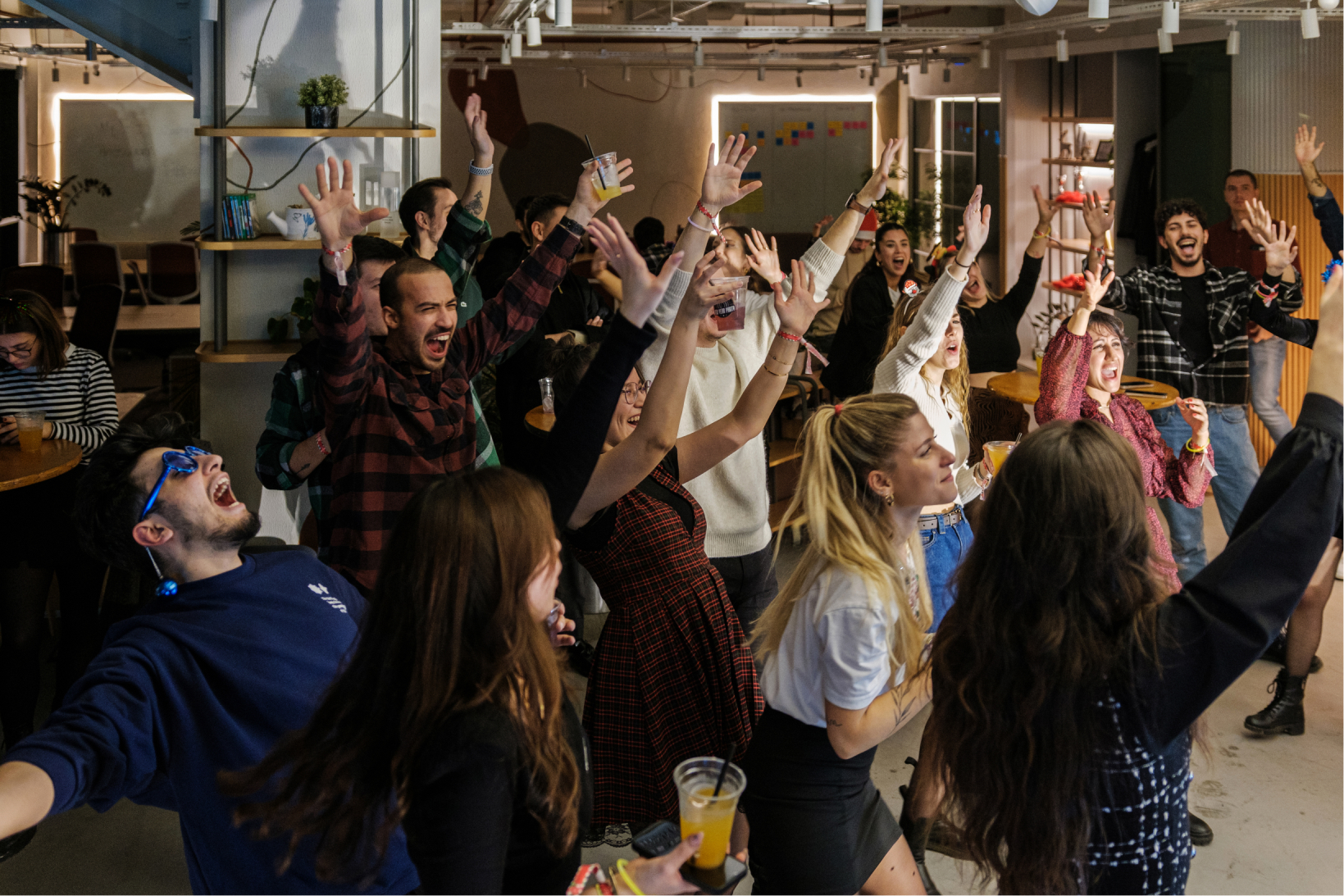 A group of people partying and screaming with their hands in the air at Atolye15’s new year party in Izmir.