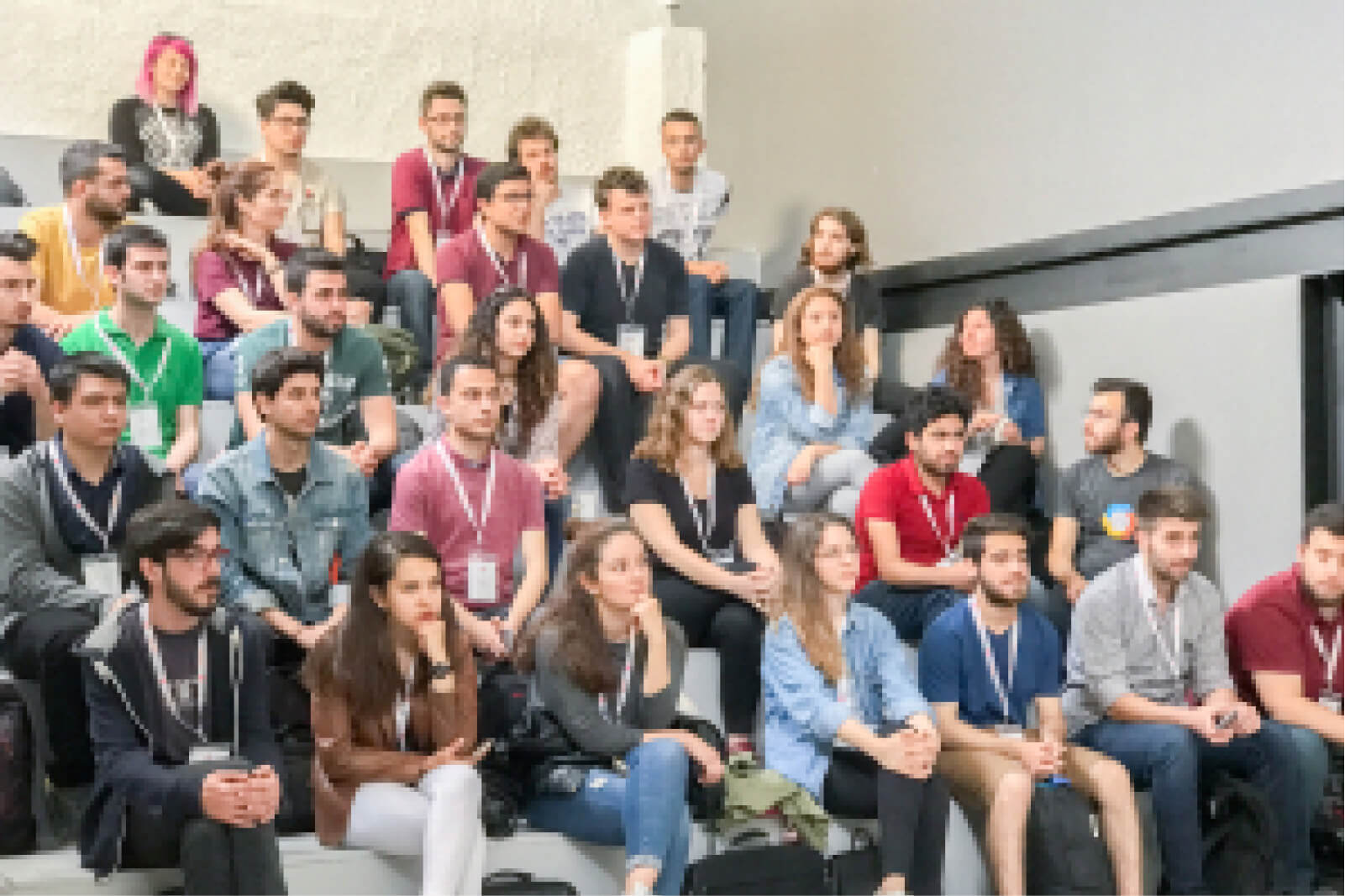 A group of young people sitting in a lecture hall listening to a presentation at the Atolye15 Internship Bootcamp.