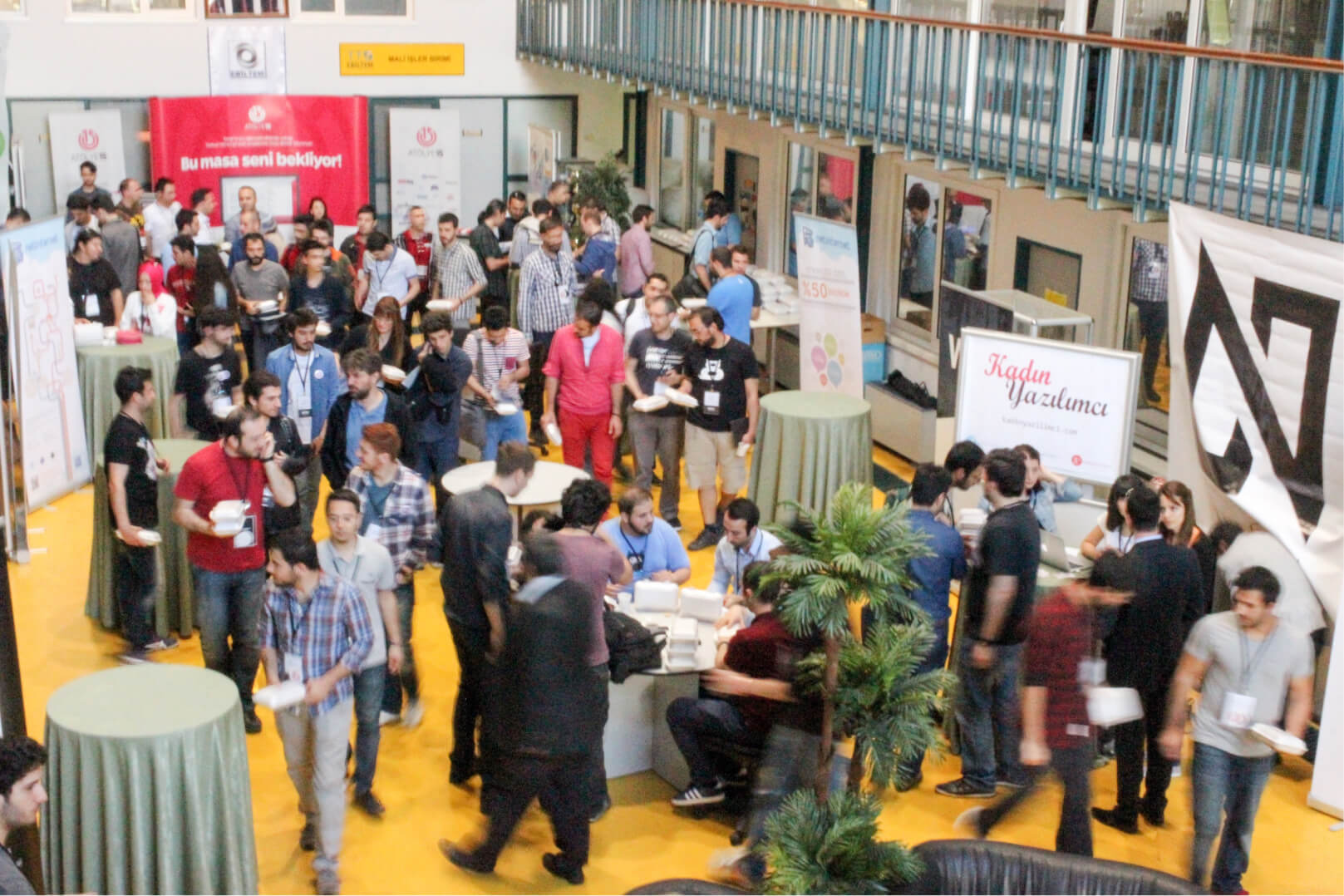 A crowd of people, walking around, talking, and networking at WTK’14 by Atolye15.