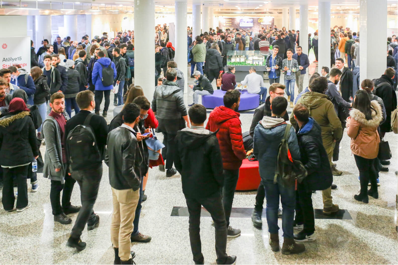 A crowd of people standing in a hall waiting for WTK’18 by Atolye15.