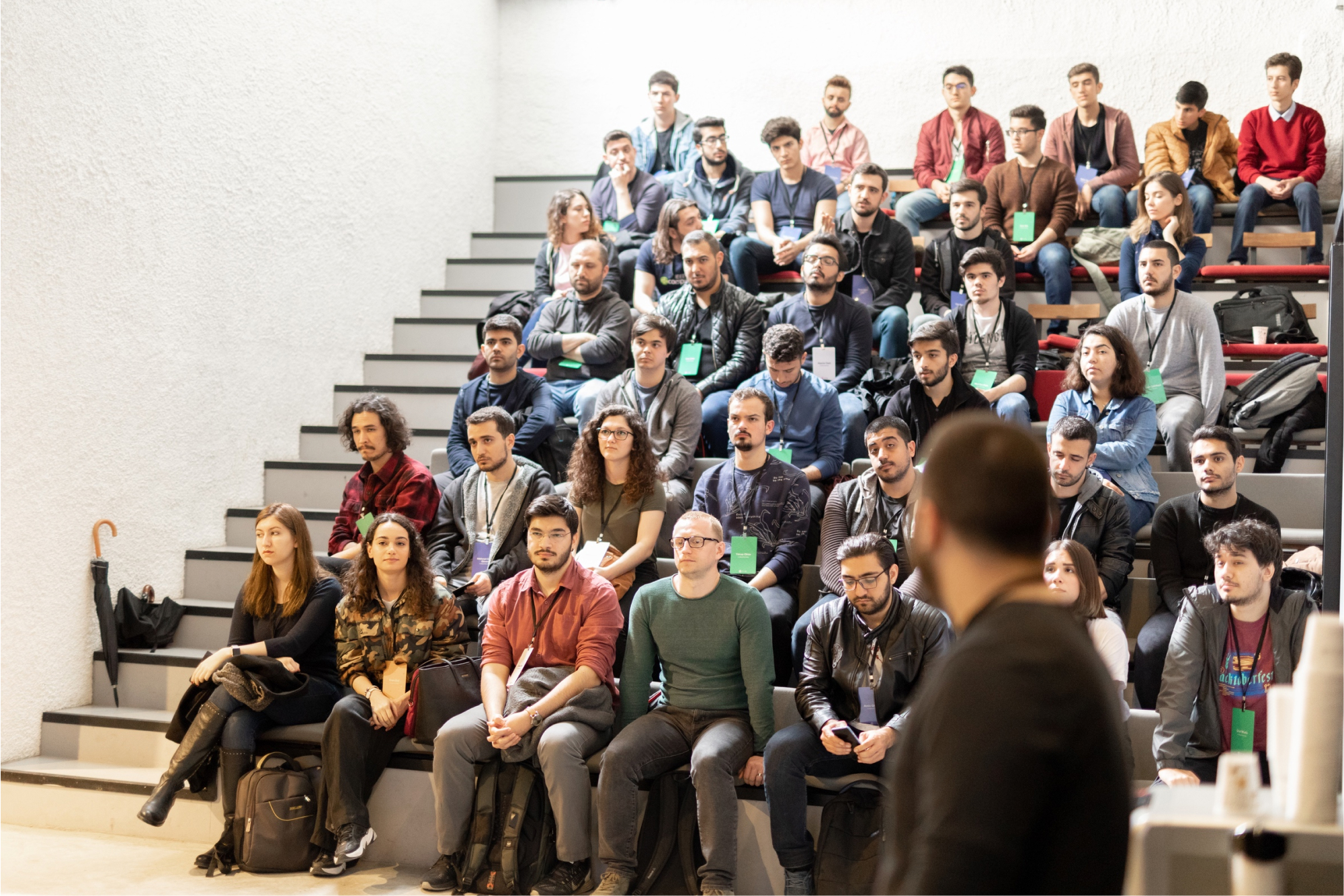 A crowd of people in a lecture hall listening to a presentation at the Atolye15 internship Bootcamp.