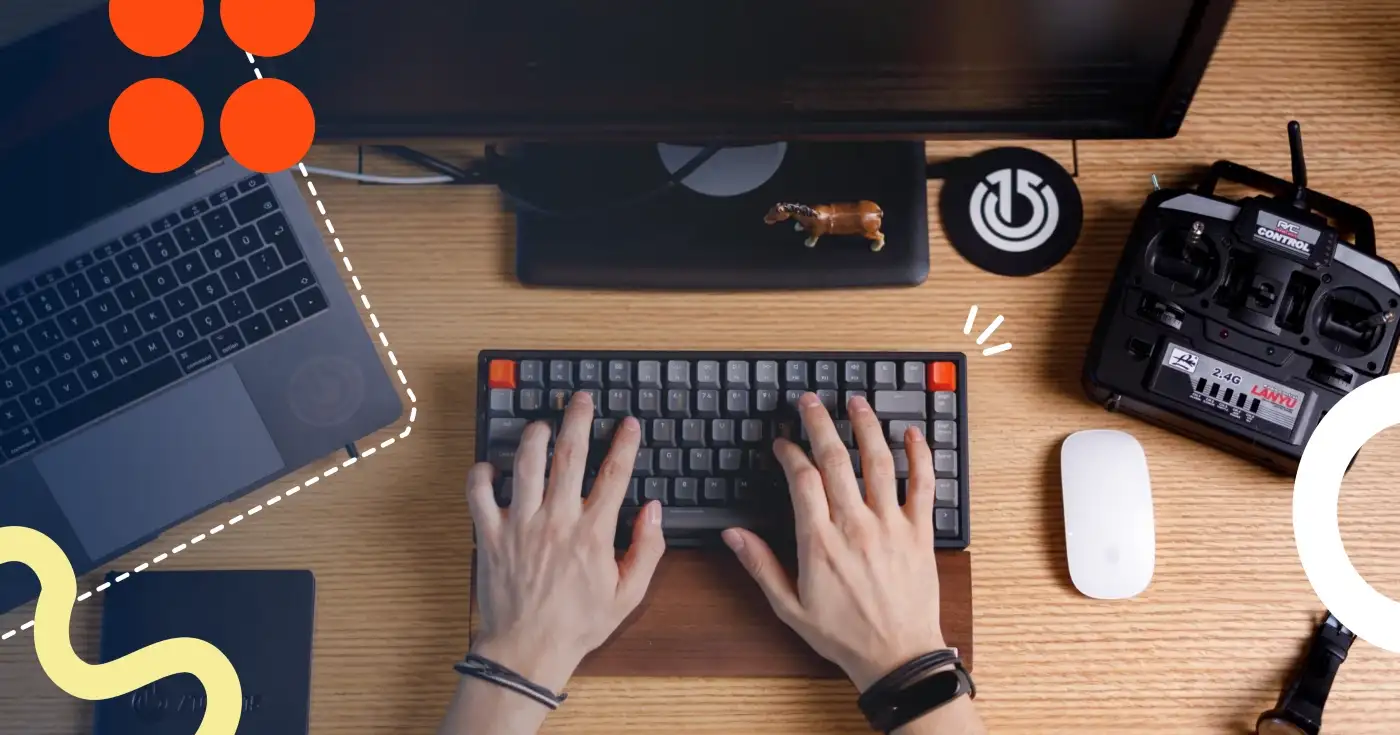 A pair of hands on a keyboard, next to a MacBook, a white Apple magic mouse, and a coaster with the Atolye15 logo on it.