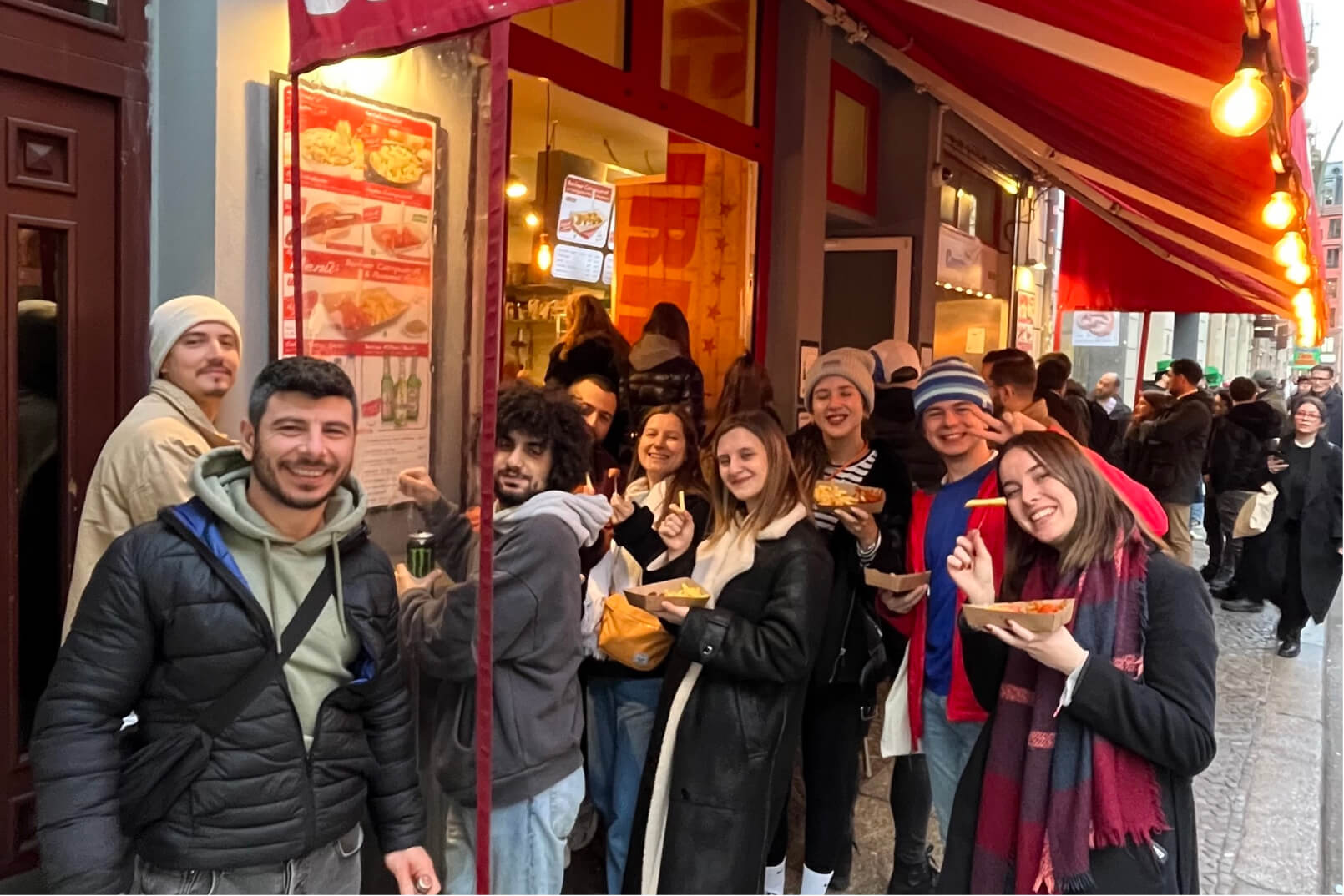 The Atolye15 Team eating famous German currywurst in the streets of Berlin.