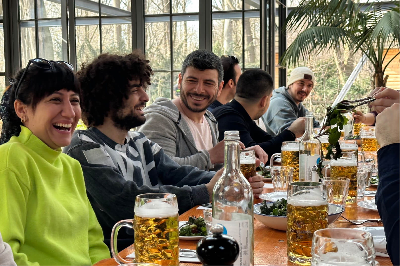 A group of Atolye15 employees having lunch and drinking German beer in a Biergarten in Berlin.