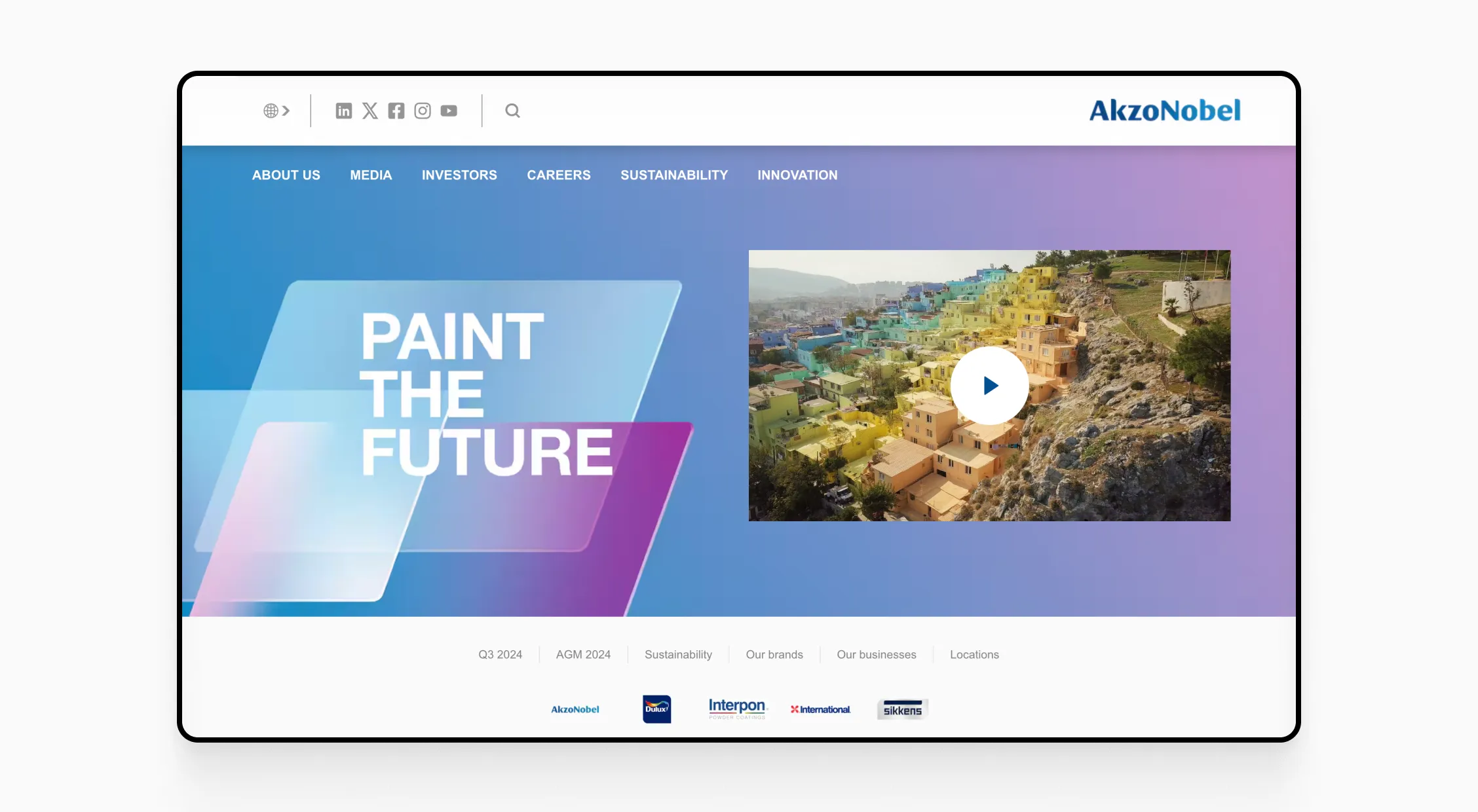 AkzoNobel homepage with 'Paint the Future' slogan and an image of hillside homes painted in vibrant colors.